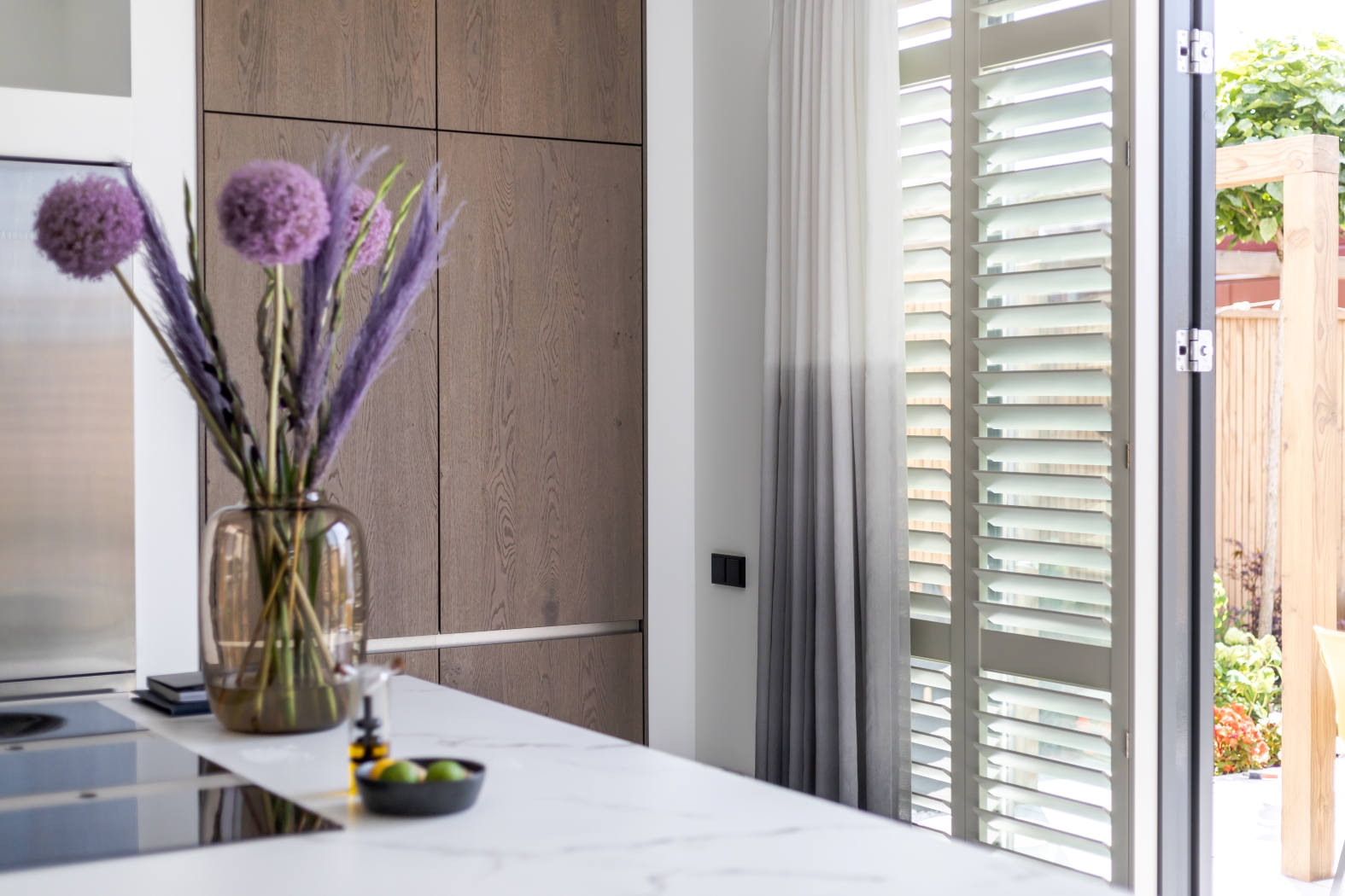 How to pair plantation shutters with curtains